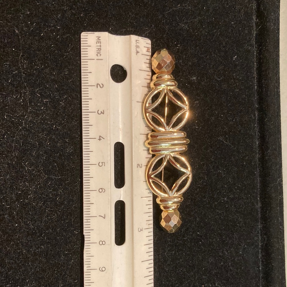 Gold tone open work bar pin. Givenchy.
